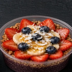 Açaí Berry bowl: açaí base with granola, strawberries, banana slices, blueberries and honey