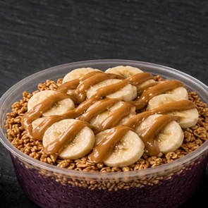 Açaí Power super bowl: açaí base topped with banana slices and a peanut butter drizzle