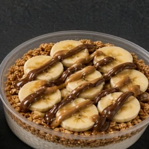 Almond Joy bowl: coconut base with granola, banana slices, almond butter and a Nutella drizzle