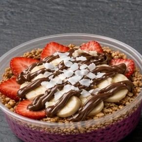 Chocolate Dragon bowl: dragon fruit base with granola, strawberries, banana slices and a Nutella drizzle