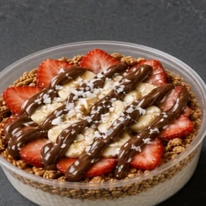 Coco Nutty bowl: coconut base with granola, strawberries, banana and a Nutella drizzle