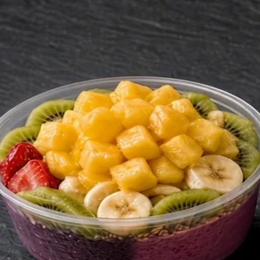 Wonder Bowl: half dragon fruit, half açaí base topped with pineapple chunks, kiwi slices, strawberries and banana