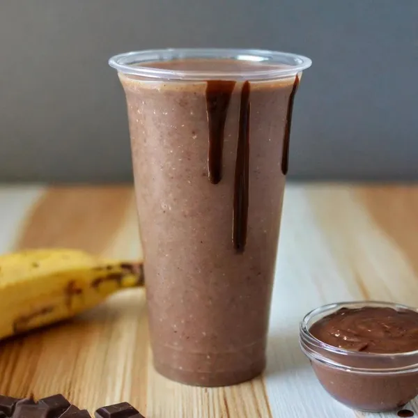 Nutty Chocolate smoothie made with chocolate almond milk, vegan chocolate protein, peanut butter, Nutella, banana, peanut butter & Nutella drizzle